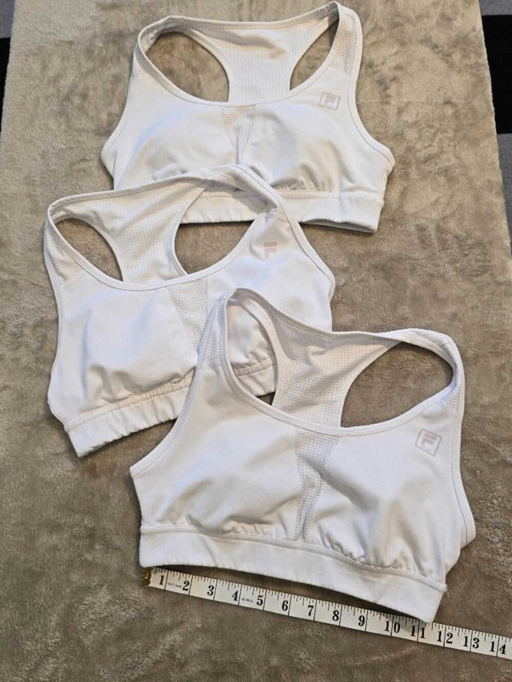 3xFILA sports athletic support tops for women in white.